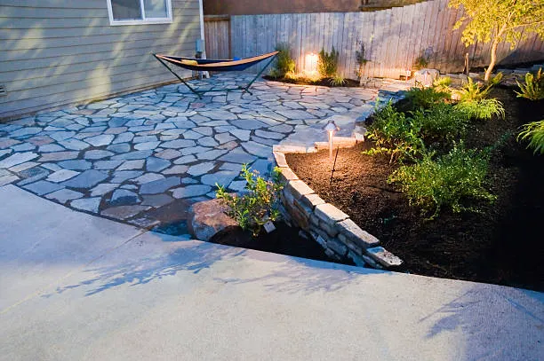 Hardscape patio and landscape area showing defensible space principles near a home